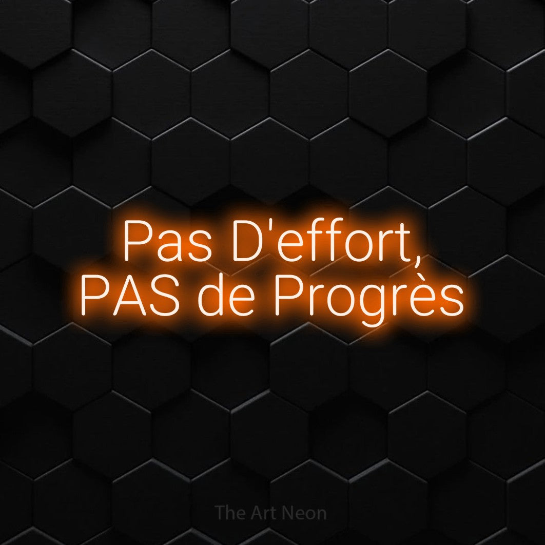 “Pas d'effort, pas de progrès” LED neon sign in orange, with rounded sans-serif lettering across 2 lines, shown against black hexagonal wall tiles.