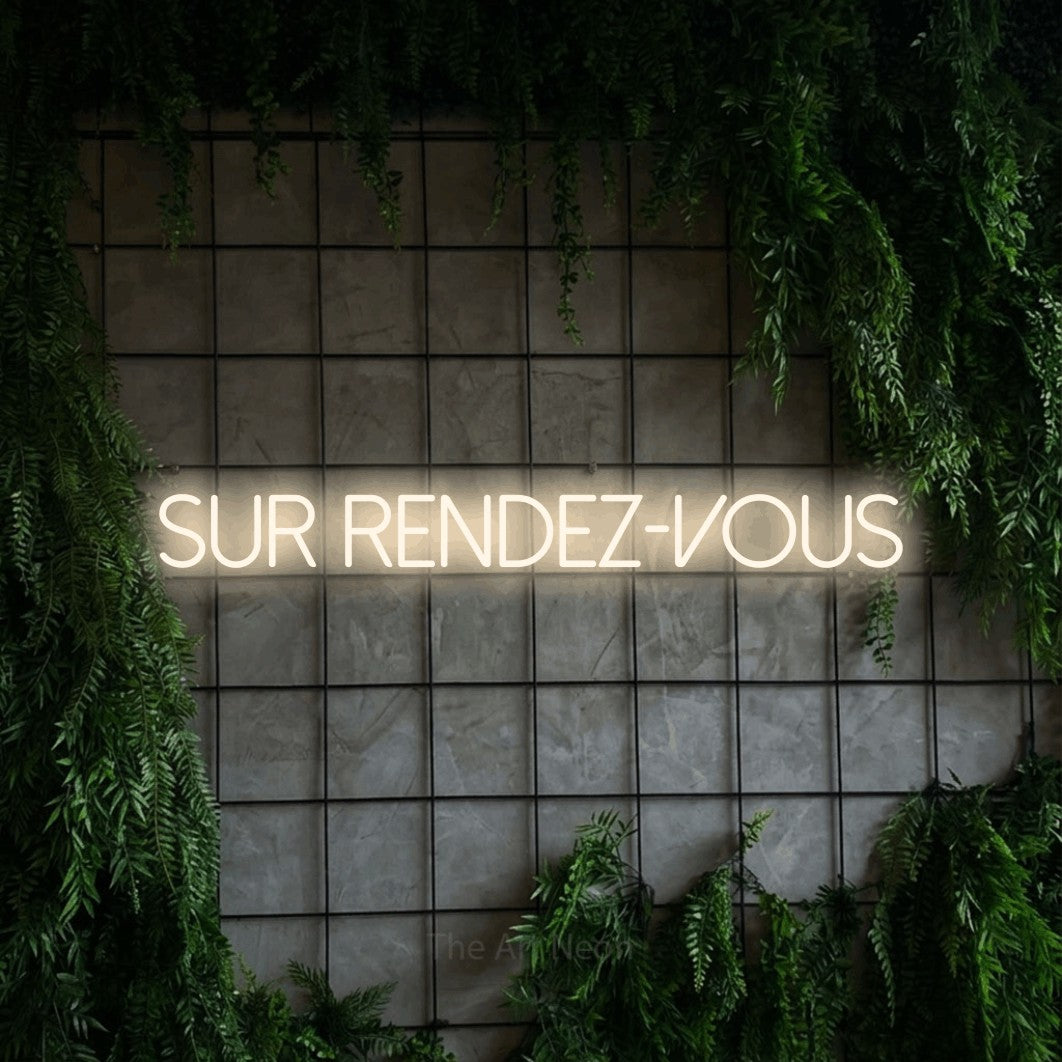 “Sur rendez-vous” LED neon sign in warm white, with thin sans-serif lettering, shown against an ivy-covered concrete grid.