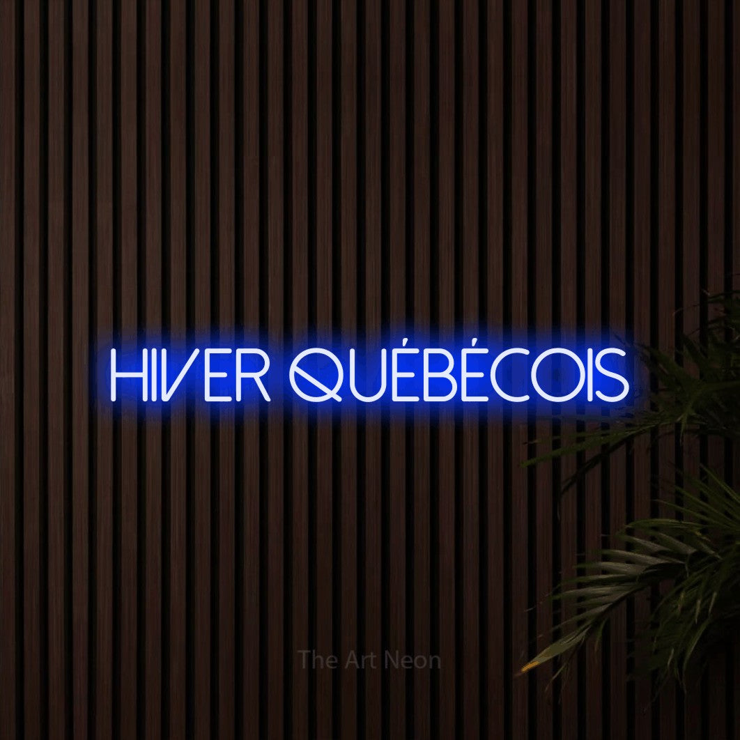 “Hiver québécois” LED neon sign in blue, with thin sans-serif lettering, shown against dark wooden wall slats.