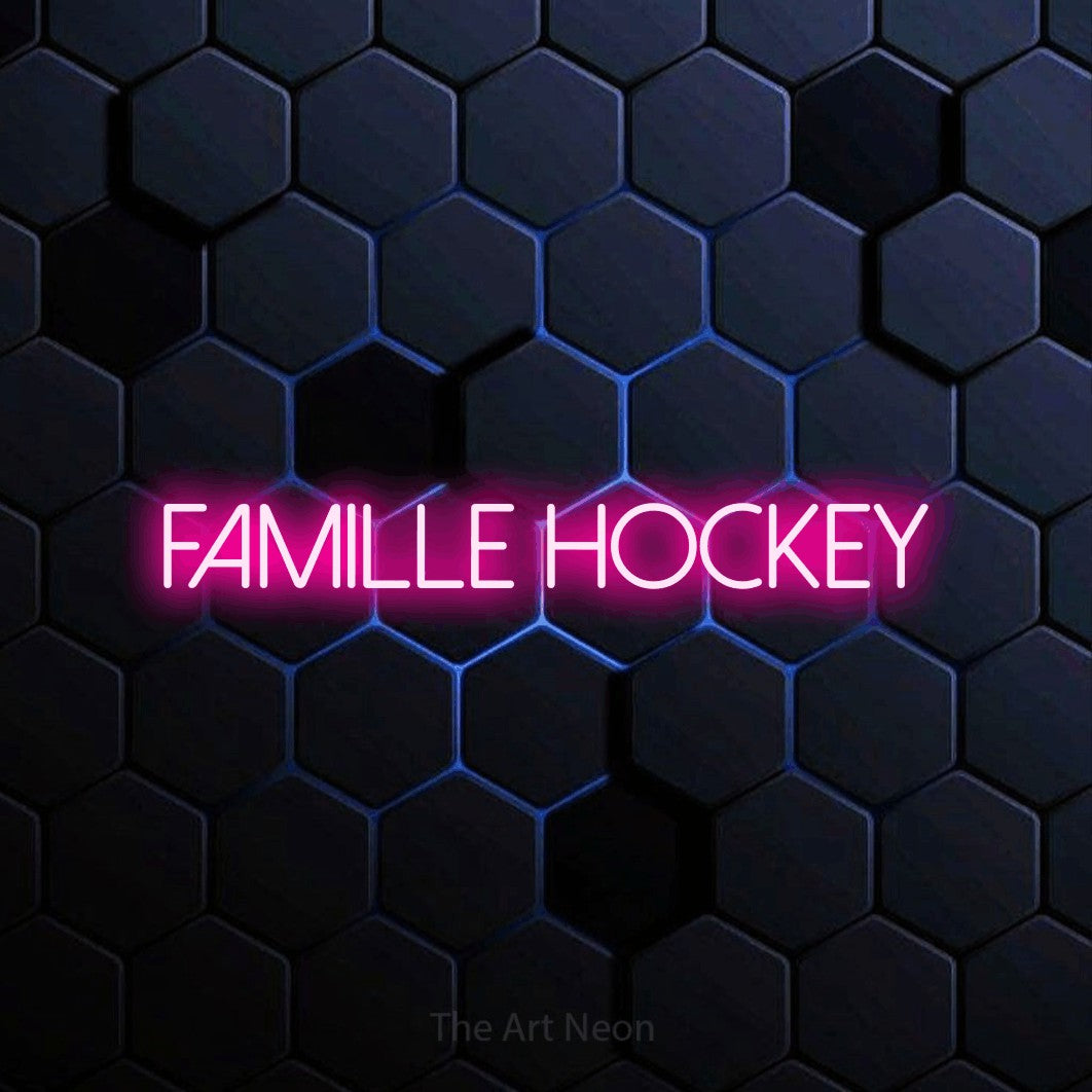 “Famille hockey” LED neon sign in hot pink, with thin sans-serif lettering, shown against a dark blue honeycomb pattern.