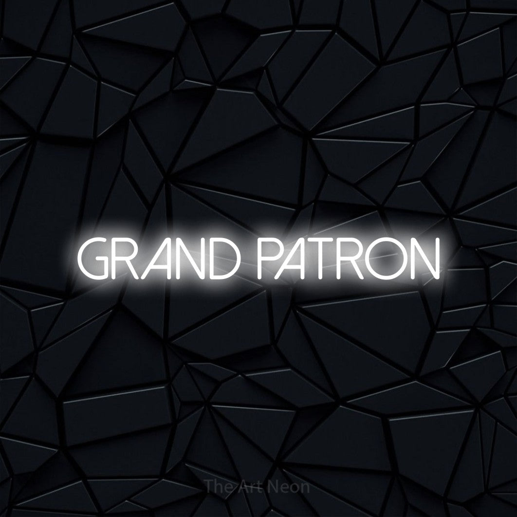 “Grand patron” LED neon sign in cool white, with thin sans-serif lettering, shown against a black polygonal surface.