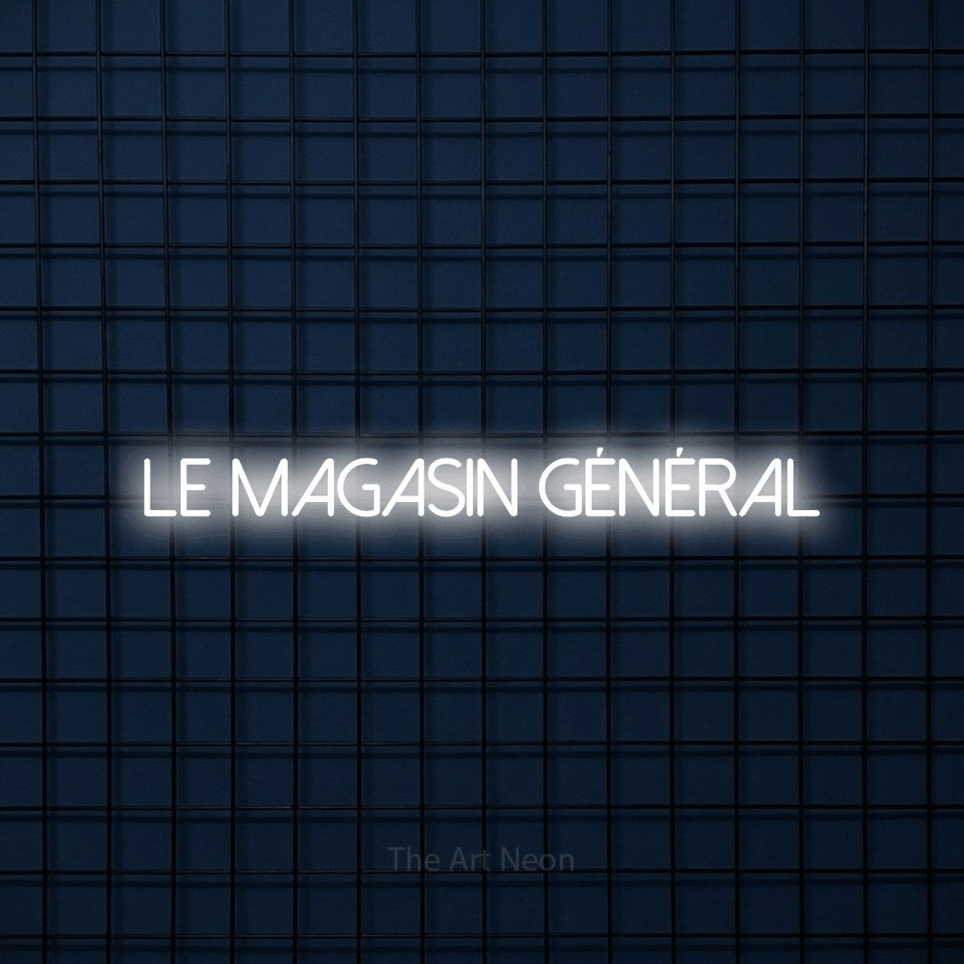 “Le magasin général” LED neon sign in cool white, with thin sans-serif lettering, shown against a dark blue grid.