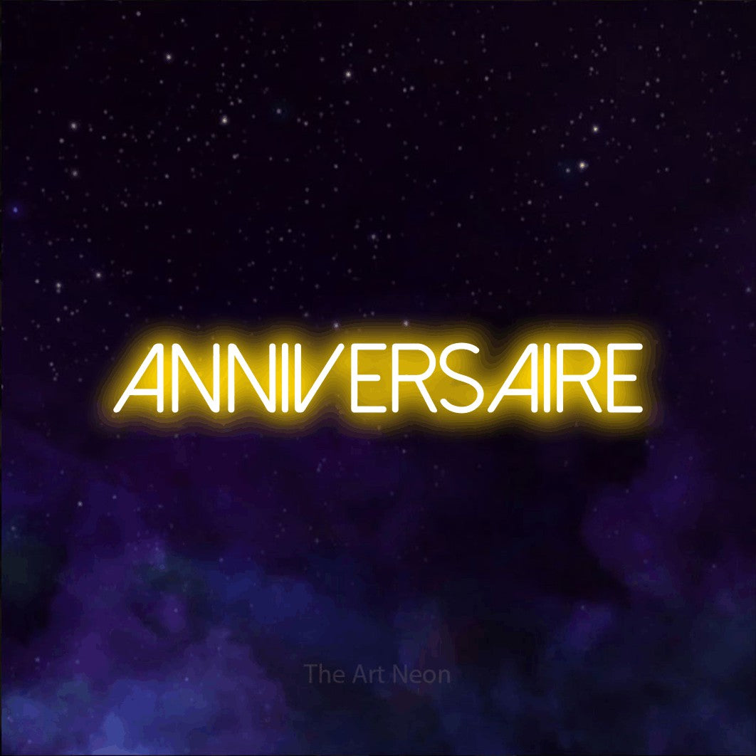 “Anniversaire” LED neon sign in yellow, with thin sans-serif lettering, shown against a purple galaxy backdrop.