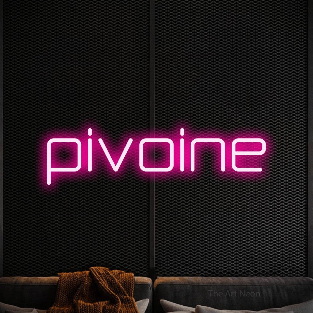 “Pivoine” LED neon sign in hot pink, with rounded geometric lettering, shown against a modern dark-toned seating area.