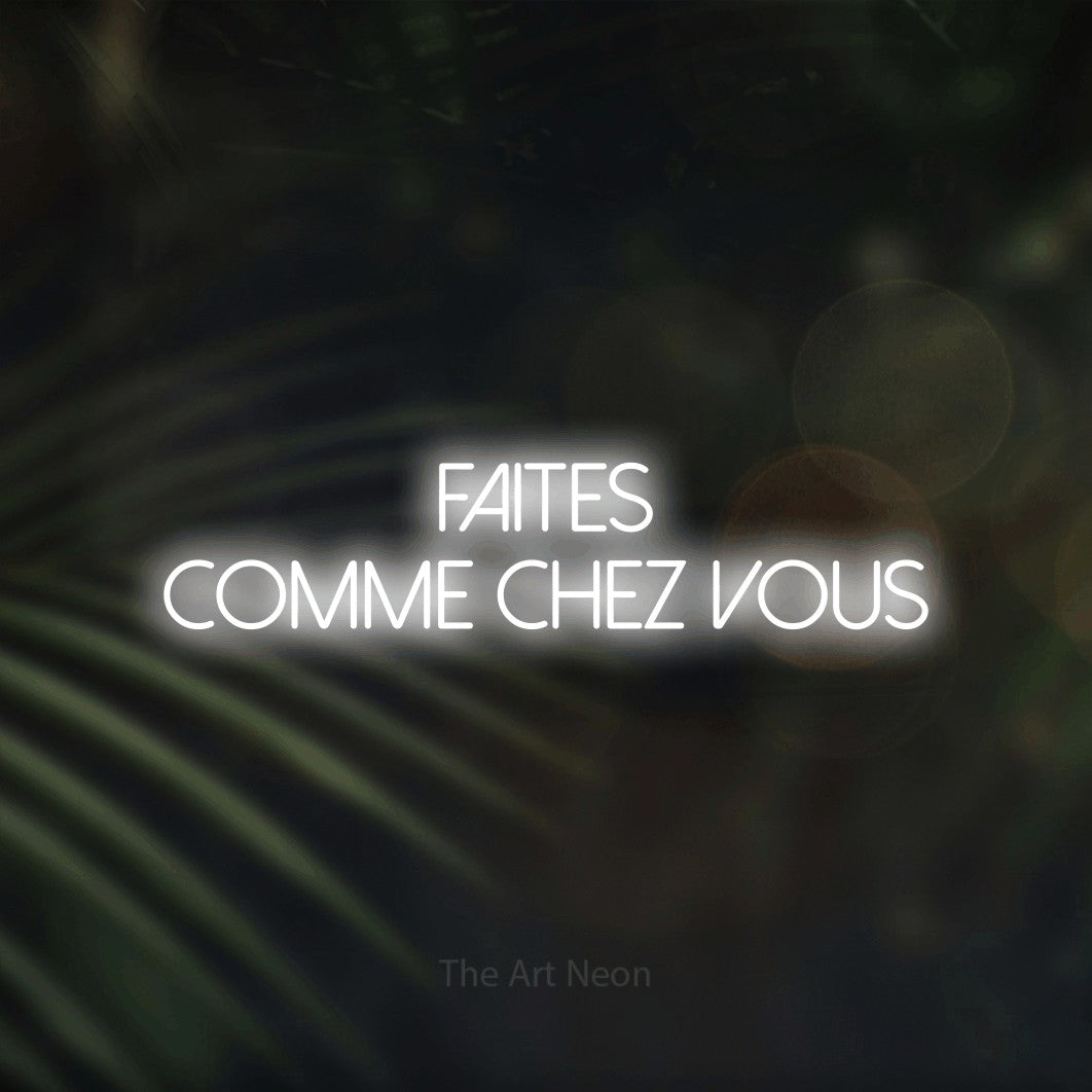 “Faites comme chez vous” LED neon sign in cool white, with thin sans-serif lettering across 2 lines, shown against a blurred palm and bokeh-light backdrop.