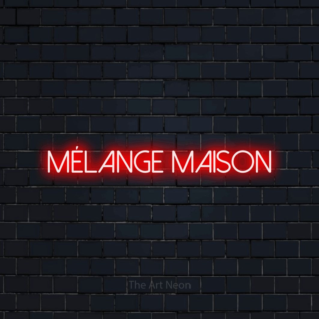 “Mélange maison” LED neon sign in red, with thin sans-serif lettering, shown against a dark navy brick wall.